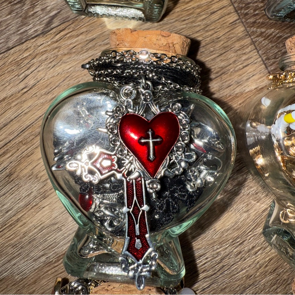Heart-Shaped Glass Bottle with Red Cross Pendant